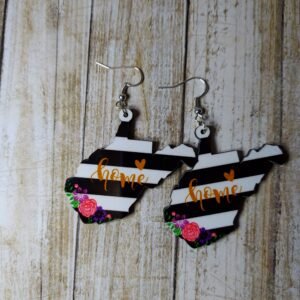 “West Virginia state-shaped earrings with black and white stripes, orange ‘home’ text, floral accents, and rustic charm