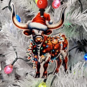 Handmade MDF wood Christmas ornament featuring a longhorn cow wearing a Santa hat and colorful Christmas lights