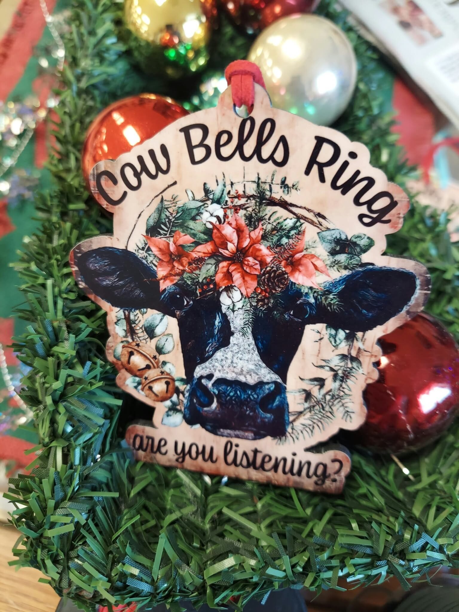 Cow Bells Ring Are You Listening? Handmade MDF Wood Cow Christmas Ornament 1 Handmade MDF wood Christmas ornament featuring a black and white cow with poinsettias, greenery, and the phrase Cow Bells Ring Are You Listening