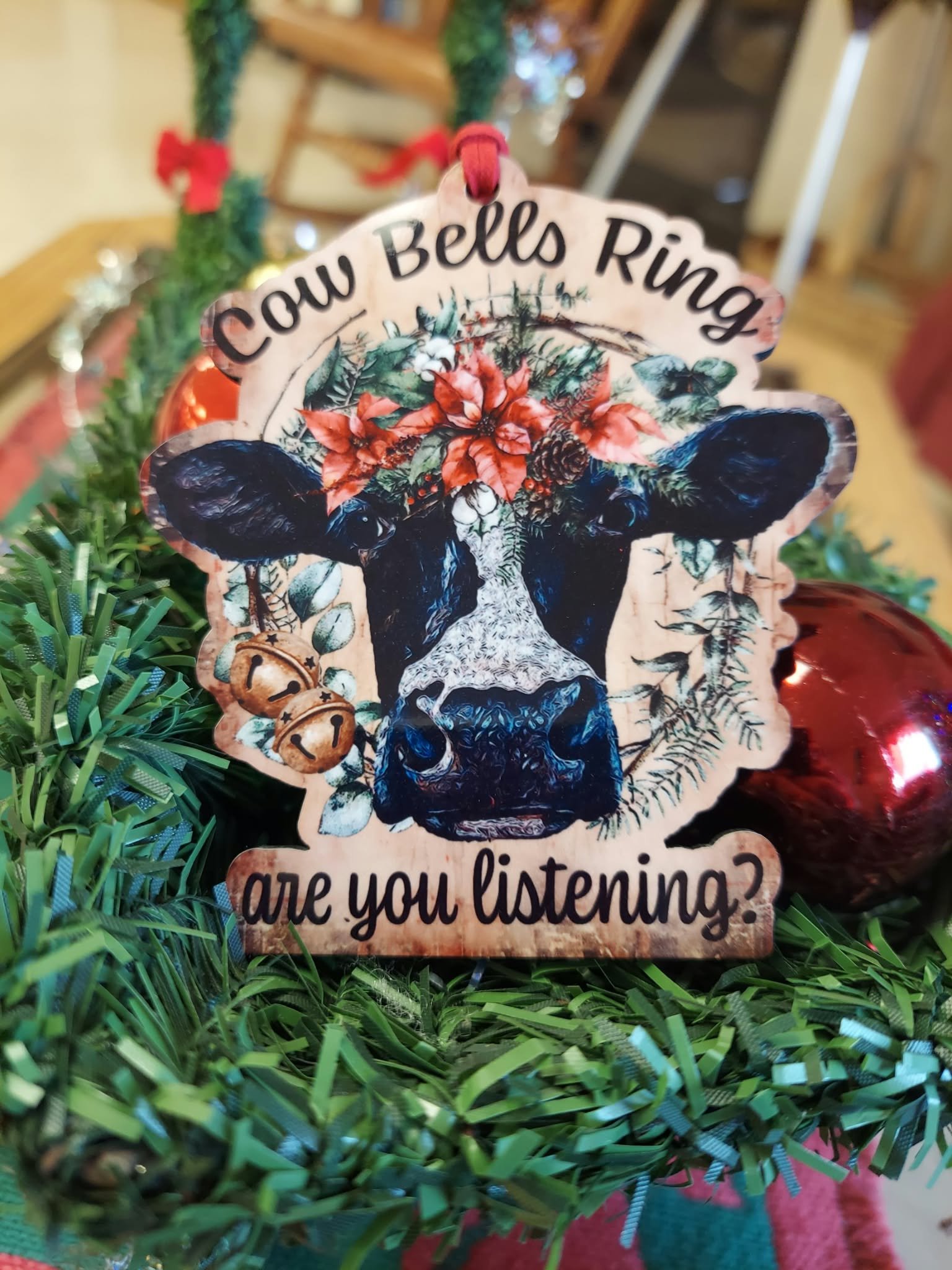Cow Bells Ring Are You Listening? Handmade MDF Wood Cow Christmas Ornament 3 Handmade MDF wood Christmas ornament featuring a black and white cow with poinsettias, greenery, and the phrase Cow Bells Ring Are You Listening