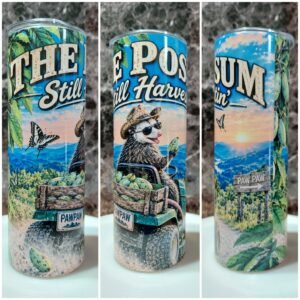 Tumbler with a possum in sunglasses and a straw hat driving a green utility vehicle loaded with pawpaws, with the words The Possum Still Harvestin'