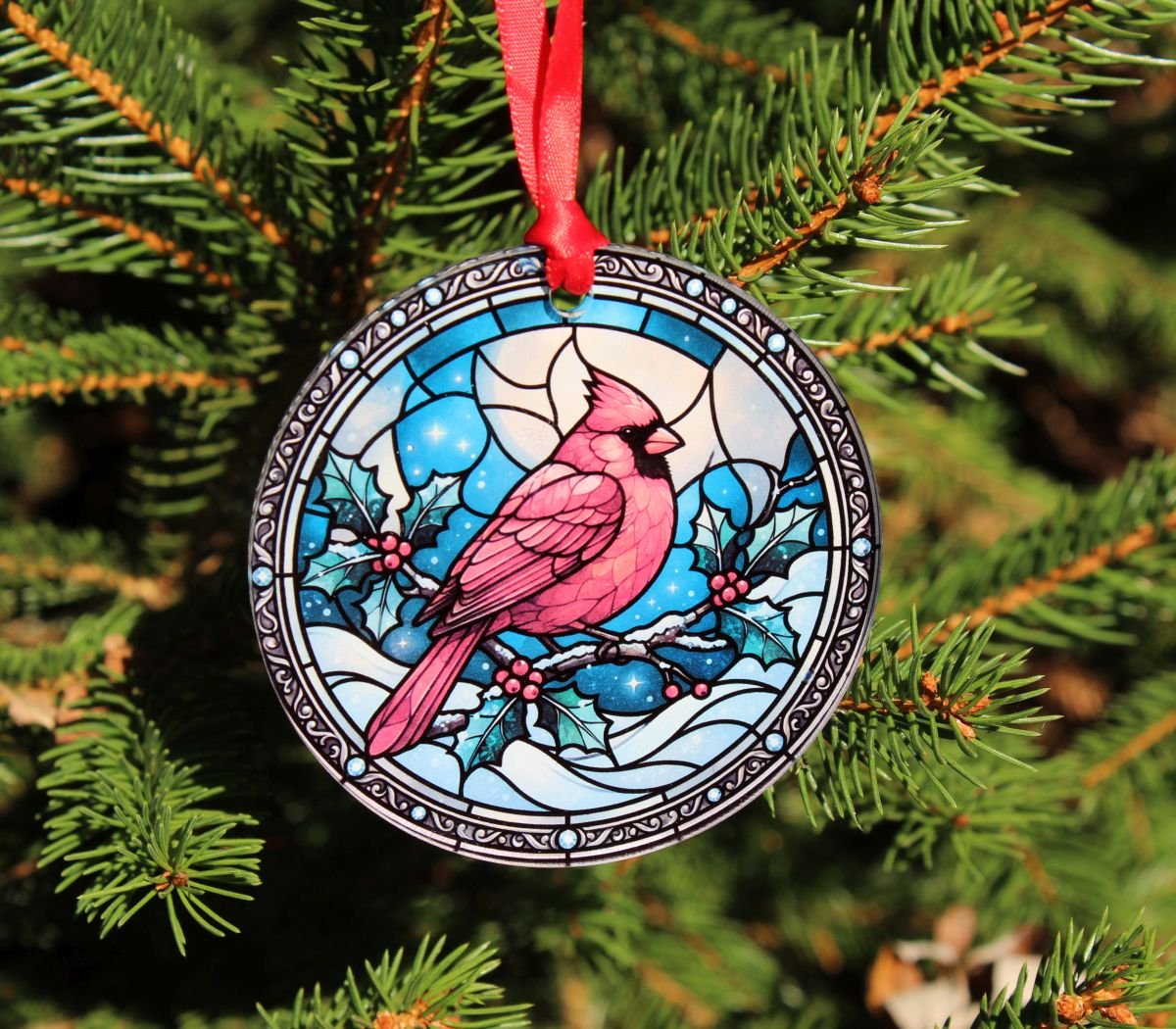 Red Cardinal Glass Christmas Ornament – Faux Stained Glass Design 1 Red cardinal glass Christmas ornament with colorful faux stained-glass design and red hanging ribbon, displayed on a Christmas tree.